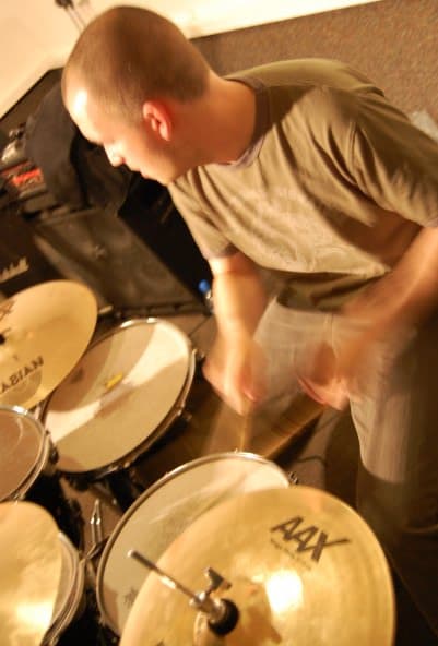 James playing drums, action shot